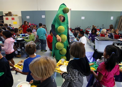 A USDA intern promotes the Farm to School program at an Oregon elementary school / AP