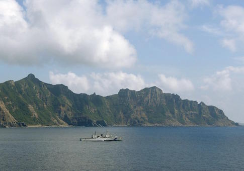 Photo taken from a Kyodo News airplane shows Uotsuri (back), one of the five main islands in the Japanese-controlled Senkaku group, in the East China Sea on Sept. 11, 2013