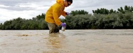 Hydrologic Technician Ryan Parker gathers water samples from the San Juan River