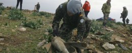 Soldier checks the remains of Israeli artillery shells along Lebanon's border / AP