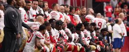 Members of the San Francisco 49ers kneel for the National Anthem / Getty Images
