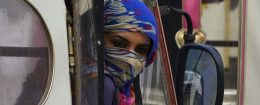 A Pakistani woman looks out from a pink rickshaw at a rally to rise awareness of women's equality and empowerment on Oct. 14, 2017 / Getty Images