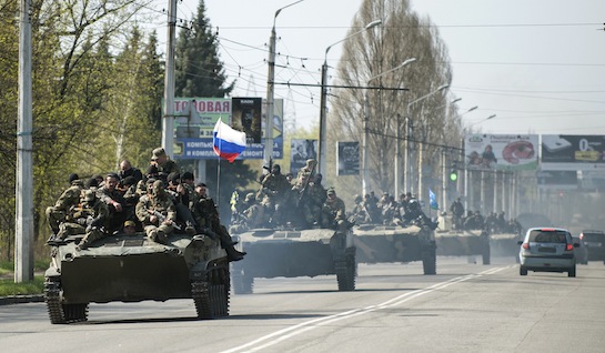 A column of combat vehicles fly the Russian flag on the road to the eastern Ukrainian city Kramatorsk on April 16, 2014. (AP)