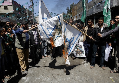 Palestinians burn replicas of the Israeli flag during a rally