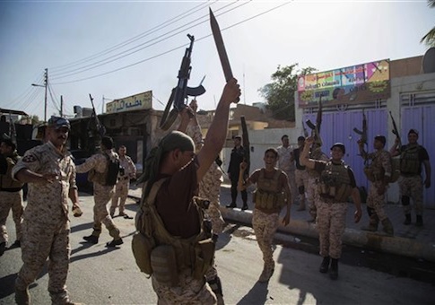 Iraqi security forces celebrate after clashes with followers of Shiite cleric Mahmoud al-Sarkhi