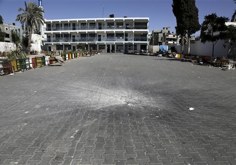 A crater from an Israeli strike is seen in the yard of the U.N. school in Beit Hanoun, in the northern Gaza Strip