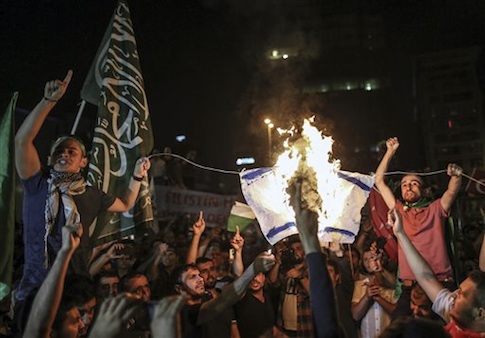 Protesters burn an Israeli flag during a protest rally outside the Israeli consulate in Istanbul, Turkey
