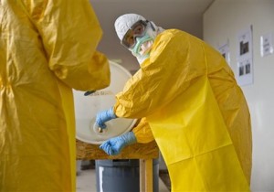A licensed clinician sanitizes his hands after a simulated Ebola training session