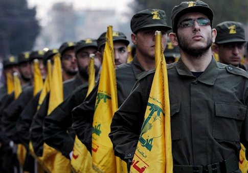 Hezbollah fighters hold their party flags