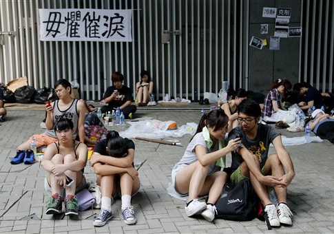 Student activists wait on the streets near the government headquarters, Thursday, Oct. 2