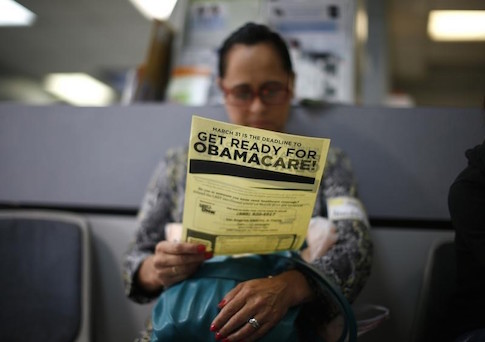 Arminda Murillo, 54, reads a leaflet at a health insurance enrollment event in Cudahy, California March 27