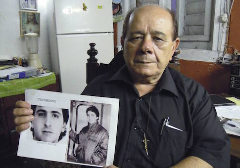 Raul Borges, 74, holds a picture of his son Ernesto Borges in his house in Havana January 2, 2015.