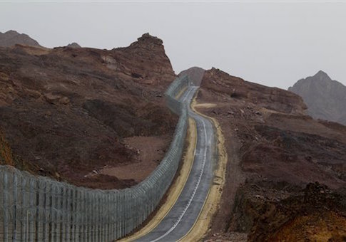 A street runs along the Egypt-Israel border security barrier near the Red Sea resort city of Eilat, southern Israel