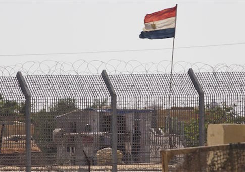 An Egyptian military officer watches at a post in Egypt's northern Sinai Peninsula, as seen from the Israel-Egypt border
