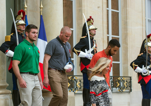 U.S. National Guardsman from Roseburg, Oregon, Alek Skarlatos, left, U.S. Airman Spencer Stone, 2nd left, and Anthony Sadler, right, a senior at Sacramento University in California, leave the Elysee Palace in Paris, France, with U.S. Ambassador to France Jane D. Hartley after being awarded with the French Legion of Honor by French President, Francois Hollande, Monday, Aug. 24, 2015. French President Francois Hollande and a bevy of officials are presenting the Americans with the prestigious Legion of Honor on Monday. The three American travelers say they relied on gut instinct and a close bond forged over years of friendship as they took down a heavily armed man on a passenger train speeding through Belgium. (AP Photo/Kamil Zihnioglu)