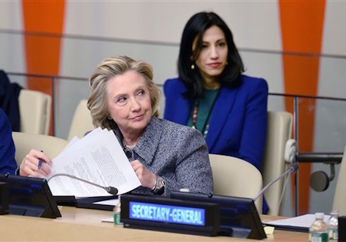 Huma Abedin sits close behind Hillary Clinton