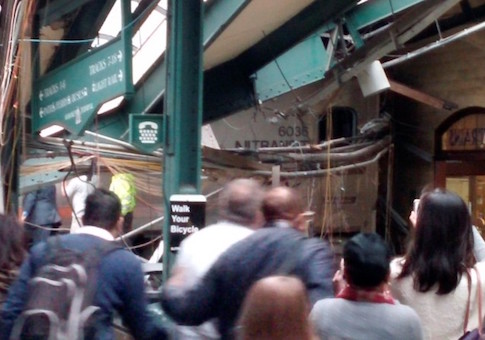 Onlookers view a New Jersey Transit train that derailed and crashed through the station in Hoboken, New Jersey,