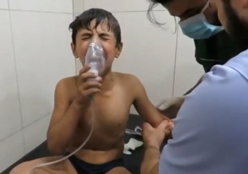 A still image taken on September 7, 2016 from a video posted on social media said to be shot in Aleppo's Al Sukari on September 6, 2016, shows a boy breathing with an oxygen mask inside a hospital, after a suspected chlorine gas attack
