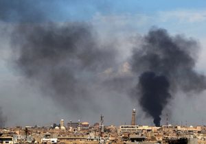 Smoke billows from behind the Great Mosque of al-Nuri in Mosul's Old City on April 17