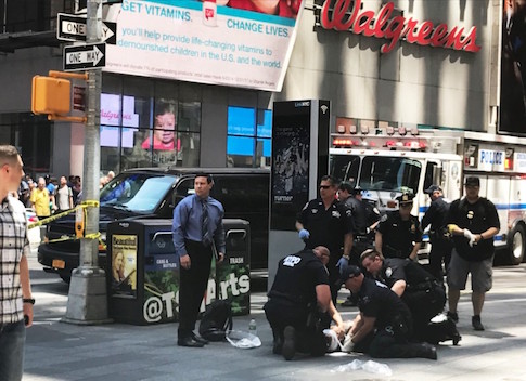 First responders are assisting injured pedestrians after a vehicle struck pedestrians on a sidewalk in Times Square