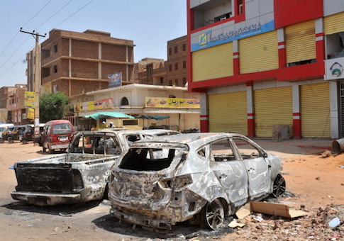 A picture taken in 2013 shows burnt vehicles in a street of the Sudanese capital Khartoum