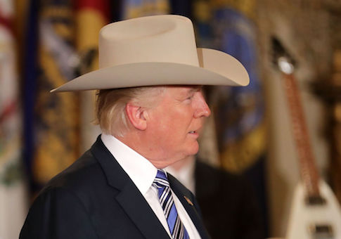 U.S. President Donald Trump wears a Stetson cowboy hat while touring a Made in America product showcase in the East Room of the White House