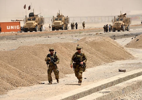 US soldiers walk at the site of a Taliban suicide attack in Kandahar on August 2