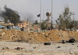 The Islamic State group flag is seen in the town of Heet, in Iraq's Anbar province in 2016