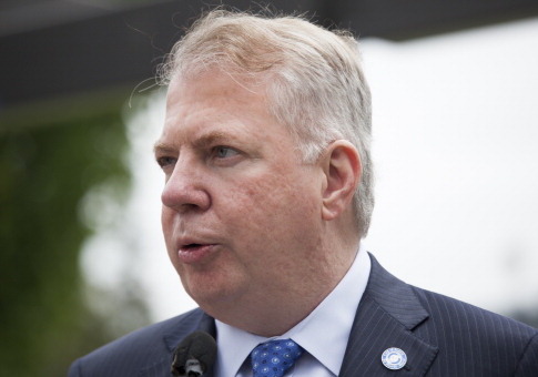 Seattle Mayor Ed Murray holds a press conference after signing a bill that raises the city's minimum wage to $15 an hour on June 3, 2014 in Seattle, Washington. / Getty Images