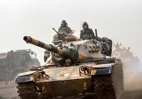 Turkish troops advance near the Syria border at Hassa, Hatay province, on January 22