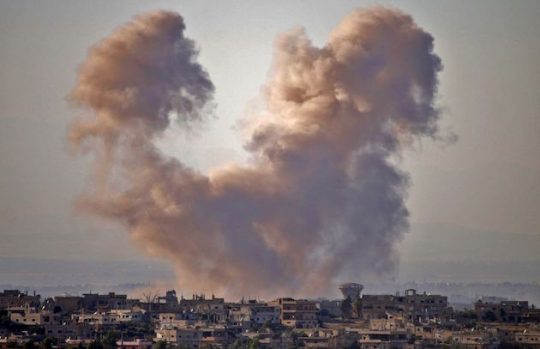 Smoke rises above opposition held areas of the Daraa province during airstrikes by Syrian regime forces