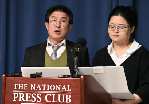 North Korean former overseas worker, Roh Hui-Chang (left), with a translator
