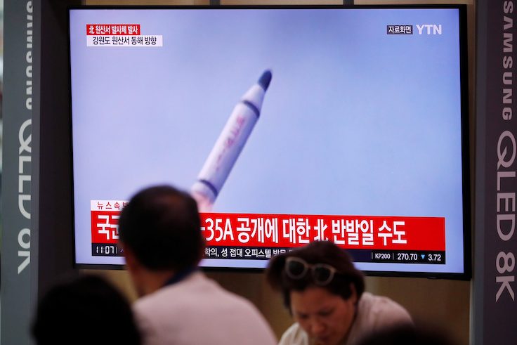 People watch a TV screening of a file footage for a news report on North Korea firing a missile that is believed to be launched from a submarine, in Seoul, South Korea