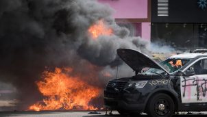 Police vehicles burn