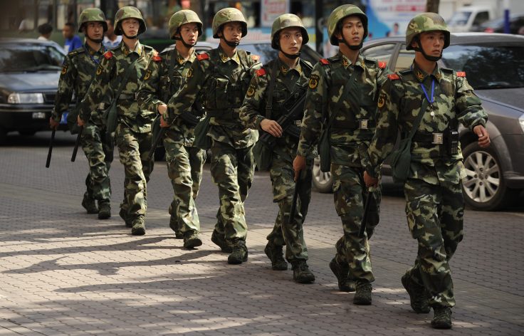 Chinese paramilatary police patrol on a street in Urumqi, capital of China's Xinjiang region