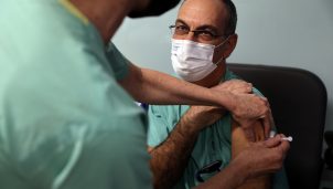 Doctor Guy Choshen, director of the COVID-19 ward in Ichilov Hospital, gets his second vaccination injection against coronavirus disease in Tel Aviv