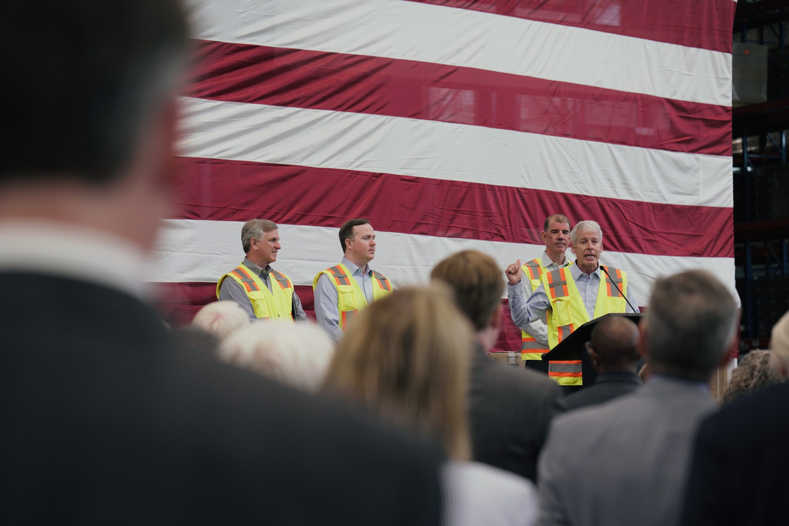 Energy Secretary Chris Wright delivers remarks at the Rinnai factory, addressing hundreds of workers. Rinnai president Frank Windsor and Rep. Brian Jack (R., Ga.) look on.