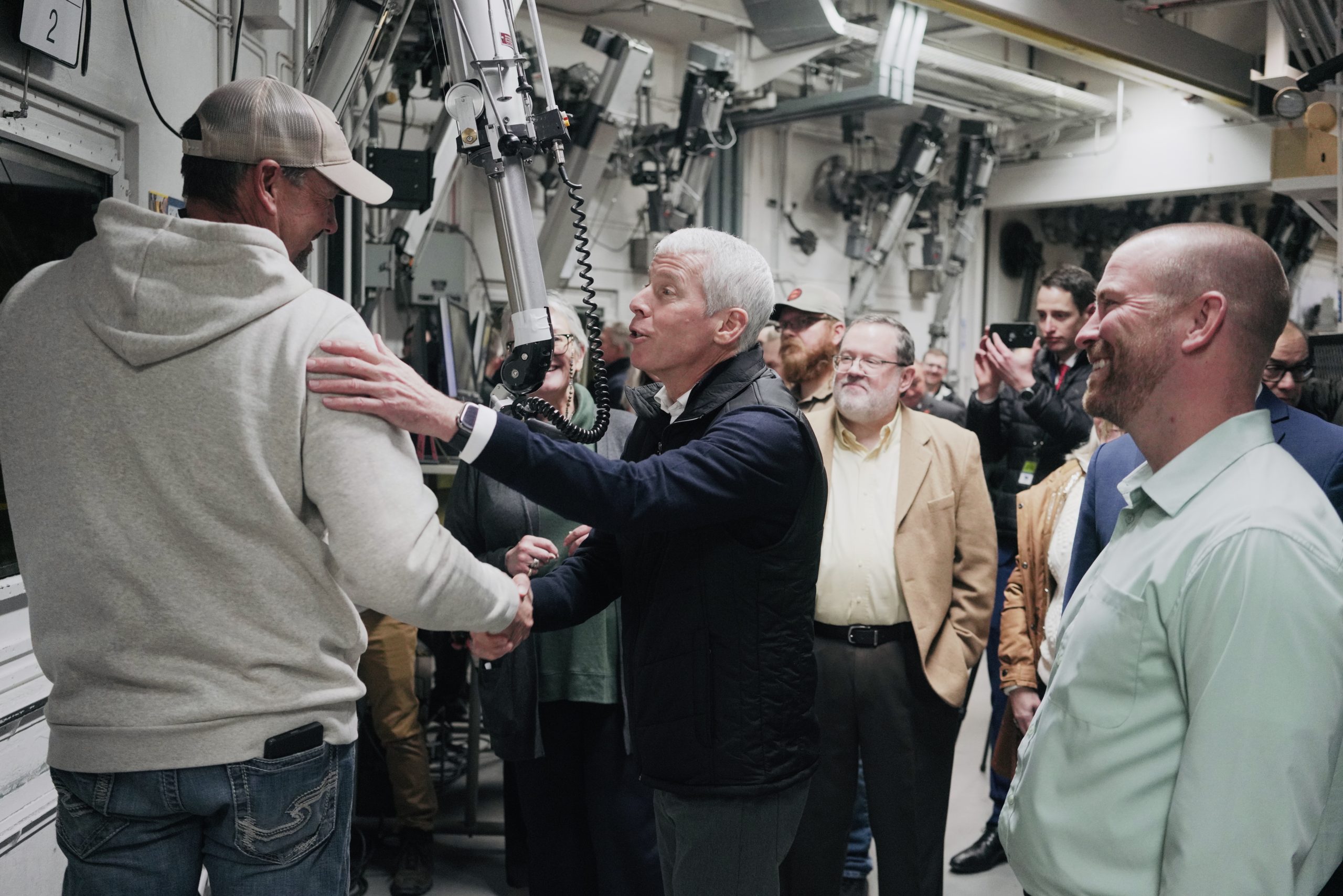 Wright greets a worker conducting experiments inside the INL's Materials and Fuels Complex.